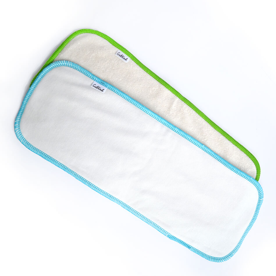 A bamboo insert with green binding and a cotton insert with blue binding.