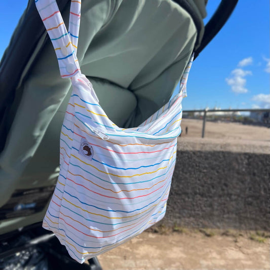 large wetbag on pushchair by beach