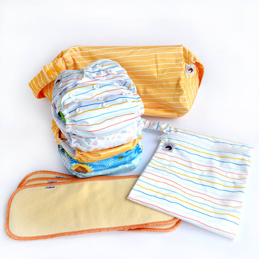 A bundle of five cloth nappies, hemp boosters and wetbags.