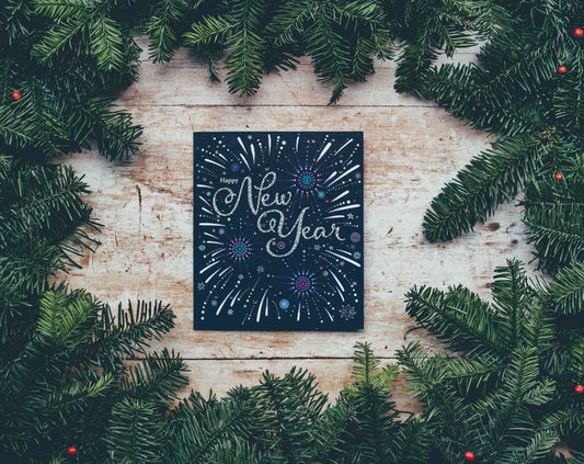 Happy New Year on a canvas surrounded by branches