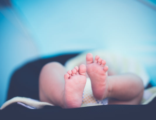 baby in disposable nappy, feet in focus