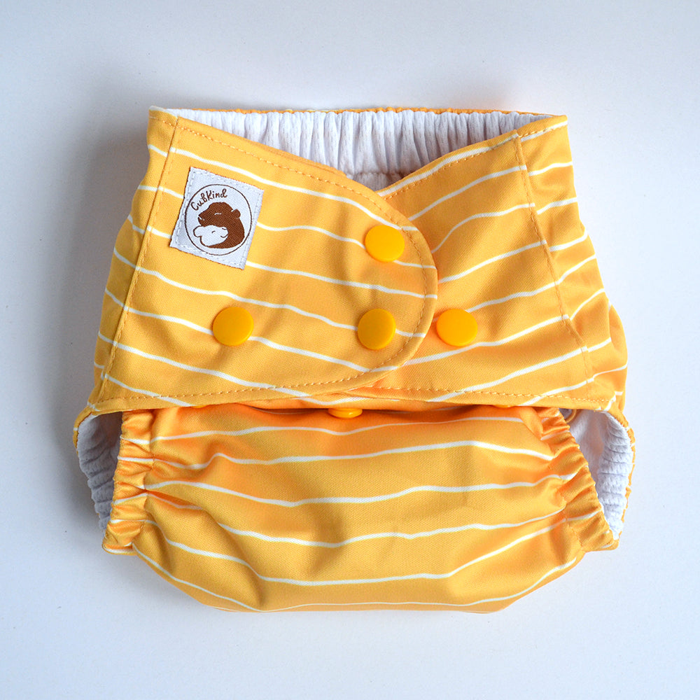A cloth nappy set to the smallest settings using poppers.