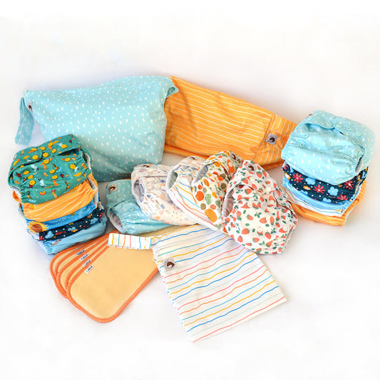 A bundle of 15 cloth nappies, 5 hemp boosters, a small wetbag, large wetbag and nappy pod