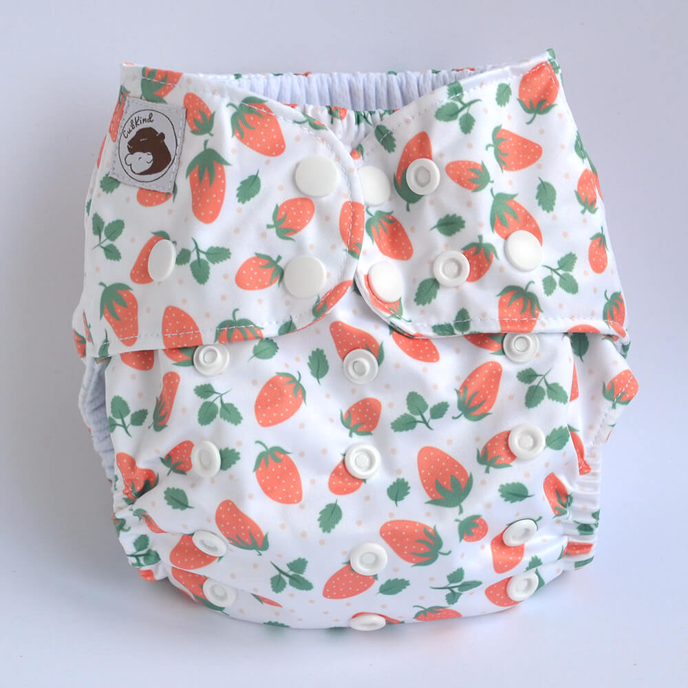 A white cloth nappy with strawberry design.