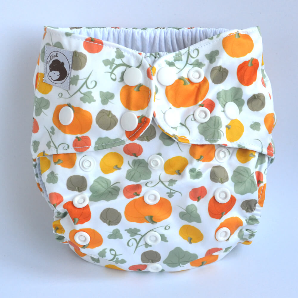 White cloth nappy with pumpkins and leaves design