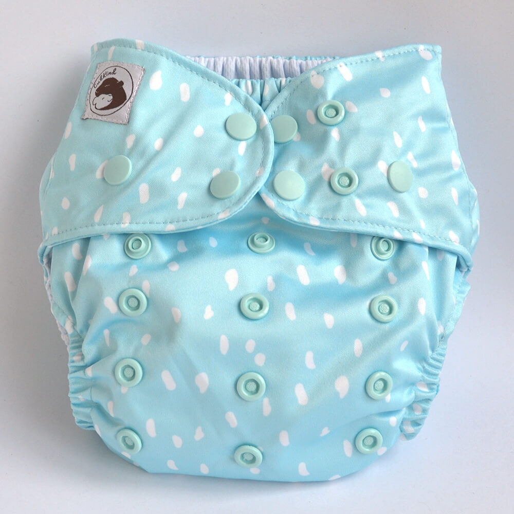 Pale blue cloth nappy with white spots.