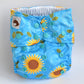 Blue cloth nappy with yellow sunflower design.